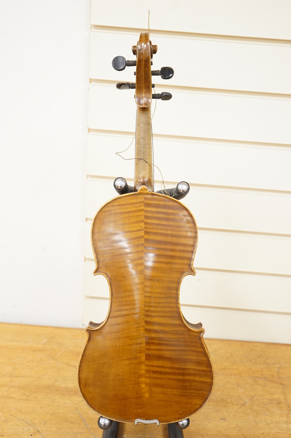 Three cased violins; a German Dresden violin, supplied by Campbell and co., Glasgow, together with another Dresden Stradivarius copy, and the remains of a European violin.